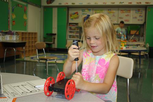 Female student building a sail car